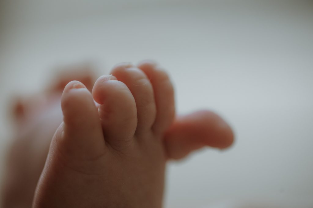 Close-up of newborn baby hands during an in-home lifestyle photography session in Hong Kong